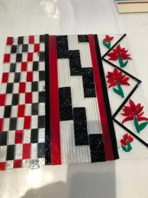 12" x 12" Table Decor is dancing with Red, Black and White. Highlighted by Red Flowers.