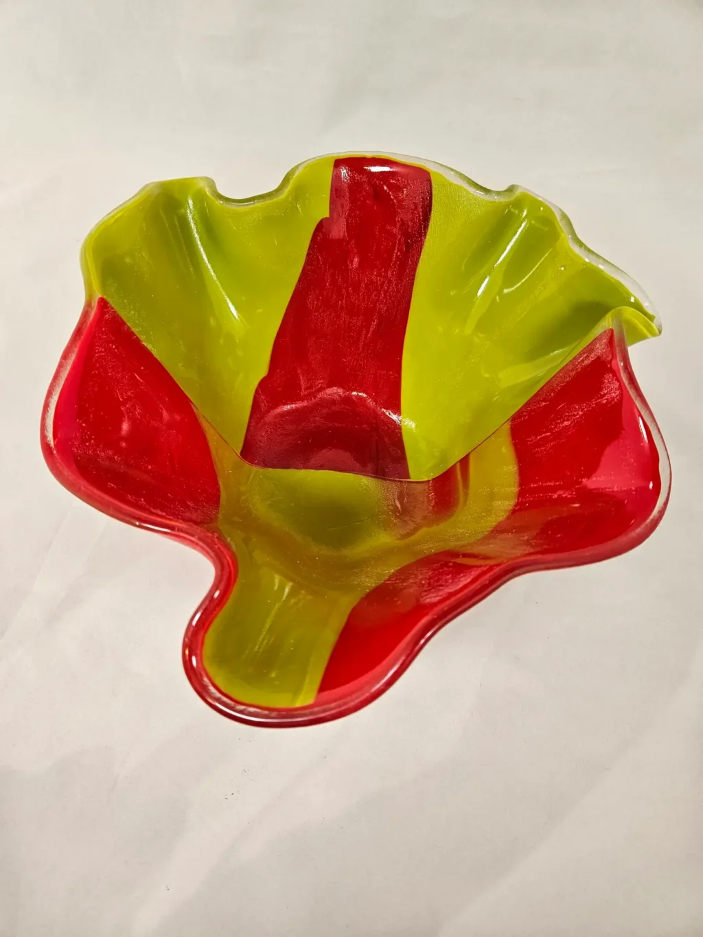 The Citrus Splash is a glass bowl with irregular, wavy edges, highlighted by vibrant red and yellow sections.