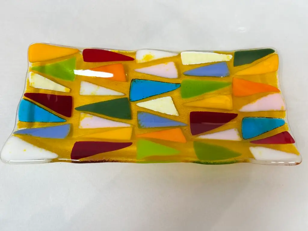 A rectangular glass dish featuring colorful triangular pieces.