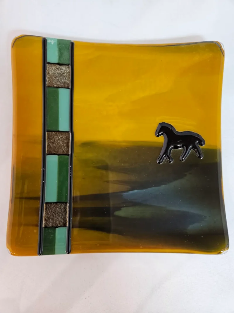 The Lone Mustang glass art piece features a black horse silhouette.