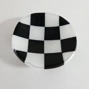 Fused glass trinket dish with black and white checkerboard pattern.